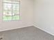 Bedroom featuring neutral carpet and a window overlooking trees and landscaping at 2601 Fairhaven Dr, Indianapolis, IN 46229