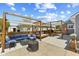 This backyard features a pergola, patio furniture, an outdoor kitchen with a grill, and a fire pit at 272 Van Buren St, Greenfield, IN 46140