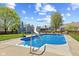 This backyard features an in-ground pool, ladder, concrete deck, manicured lawn, shed, and fenced perimeter at 272 Van Buren St, Greenfield, IN 46140