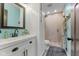 This bathroom features a white vanity, framed mirror, decorative lighting, and a tiled walk-in shower at 272 Van Buren St, Greenfield, IN 46140