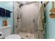 This bathroom features a tiled walk-in shower with a glass door and walls, pebble floor, and a shower head at 272 Van Buren St, Greenfield, IN 46140