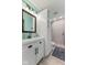 This bathroom features a white vanity, framed mirror, decorative lighting, and a tiled walk-in shower at 272 Van Buren St, Greenfield, IN 46140