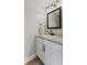 Well-lit bathroom with white vanity, countertop, framed mirror, and modern fixtures, combining style with functionality at 272 Van Buren St, Greenfield, IN 46140