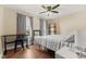 Cozy bedroom features natural light, ceiling fan, and wood-look flooring at 272 Van Buren St, Greenfield, IN 46140