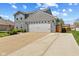 Two-story home with a two-car garage and a spacious driveway, complemented by a well-maintained lawn at 272 Van Buren St, Greenfield, IN 46140