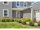 Charming home entrance featuring manicured shrubs and flower boxes under the windows at 272 Van Buren St, Greenfield, IN 46140