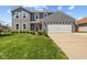 Beautiful two-story home with manicured lawn and landscaping, featuring a spacious two-car garage at 272 Van Buren St, Greenfield, IN 46140