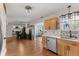 Open concept kitchen featuring natural wood cabinets and dining area with view of fireplace at 272 Van Buren St, Greenfield, IN 46140