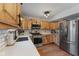 Charming kitchen featuring stainless steel appliances, wooden cabinets, and modern white countertops with subway tile backsplash at 272 Van Buren St, Greenfield, IN 46140