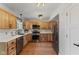 Charming kitchen with stainless steel appliances, white subway tile backsplash, and beautiful hardwood cabinetry at 272 Van Buren St, Greenfield, IN 46140