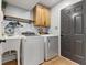 Well-organized laundry room with modern washer, dryer, sink, and ample storage space, designed for convenience at 272 Van Buren St, Greenfield, IN 46140