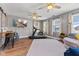 Spacious living room with hardwood floors, a ceiling fan, and large windows that let in plenty of natural light at 272 Van Buren St, Greenfield, IN 46140