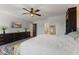 This bedroom features a ceiling fan, a large dresser with a TV, a wooden mirror, and access to the bathroom at 272 Van Buren St, Greenfield, IN 46140