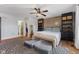 This bedroom features a ceiling fan, an accent wall, built-in shelving, and access to the closet and the bathroom at 272 Van Buren St, Greenfield, IN 46140