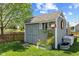 Charming storage shed decorated with various garden containers and painted in a complementary color at 272 Van Buren St, Greenfield, IN 46140