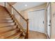 Elegant staircase with hardwood steps, iron balusters, and a contrasting white trim, leading to the upper level at 272 Van Buren St, Greenfield, IN 46140