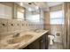 Bathroom with double sinks and tile backsplash at 3127 E 52Nd St # C, Indianapolis, IN 46205