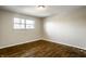 Well-lit bedroom featuring hardwood floors and a bright window at 3127 E 52Nd St # C, Indianapolis, IN 46205