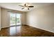 Spacious bedroom with hardwood floors, a ceiling fan, and a private balcony with sliding glass doors at 3127 E 52Nd St # C, Indianapolis, IN 46205