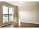 Bright bedroom featuring hardwood floors and a large window with scenic lake view, creating a serene living space at 3127 E 52Nd St # C, Indianapolis, IN 46205
