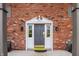 Charming brick exterior with a gray front door and decorative white trim, offering a warm welcome to this lovely home at 3127 E 52Nd St # C, Indianapolis, IN 46205