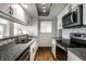 Stylish kitchen features sleek countertops, white cabinets and stainless steel appliances with bright natural lighting at 3127 E 52Nd St # C, Indianapolis, IN 46205