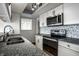 Efficient kitchen boasts stainless appliances, granite counters, and a mosaic tile backsplash for a modern touch at 3127 E 52Nd St # C, Indianapolis, IN 46205