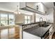 Granite counters complement mosaic tile backsplash in the kitchen, with a seamless view to the living room at 3127 E 52Nd St # C, Indianapolis, IN 46205