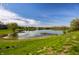 Picturesque lake view with grassy shoreline, perfect for relaxing at 3127 E 52Nd St # C, Indianapolis, IN 46205