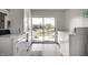 Bright laundry room with machines and sliding door access to the outside lake view at 3127 E 52Nd St # C, Indianapolis, IN 46205