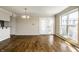 Bright living room featuring hardwood floors, a chandelier, and access to a balcony through double doors at 3127 E 52Nd St # C, Indianapolis, IN 46205