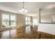 Open living space with rich hardwood floors, water views, and a breakfast bar connecting to the kitchen at 3127 E 52Nd St # C, Indianapolis, IN 46205
