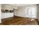 Bright living area with beautiful hardwood floors and natural light, leading to a dining area and outdoor access at 3127 E 52Nd St # C, Indianapolis, IN 46205