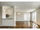 Bright living area with beautiful hardwood floors and natural light, leading to a dining area and outdoor access at 3127 E 52Nd St # C, Indianapolis, IN 46205