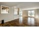 Open living area with hardwood floors, natural light, and a peek into the kitchen, ideal for modern living at 3127 E 52Nd St # C, Indianapolis, IN 46205