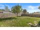 Spacious fenced backyard with grass, mature trees, and plenty of space for outdoor activities at 3283 Westpointe Dr, Franklin, IN 46131