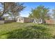 Exterior of home showcasing fenced backyard with sunroom, lush lawn and mature trees at 3283 Westpointe Dr, Franklin, IN 46131