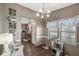 Cozy dining area with dark wood floors, a view to the kitchen and a cat tree at 3283 Westpointe Dr, Franklin, IN 46131