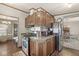 Compact kitchen features stainless steel appliances, wood cabinets, and breakfast bar at 3283 Westpointe Dr, Franklin, IN 46131