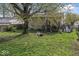Backyard featuring a large tree, green grass, and stairs leading to a deck at 3432 Joan Pl, Indianapolis, IN 46226