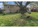 Backyard featuring a large tree, green grass, and stairs leading to a deck at 3432 Joan Pl, Indianapolis, IN 46226
