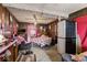 This bedroom has wood-paneled walls, a bed with pink bedding, a ceiling fan, and a pink floor rug at 3432 Joan Pl, Indianapolis, IN 46226