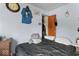 This bedroom has light-blue walls, a wooden dresser, and a bed with a black comforter at 3432 Joan Pl, Indianapolis, IN 46226