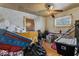 This secondary bedroom could be great for an office or storage space with a ceiling fan and window at 3432 Joan Pl, Indianapolis, IN 46226