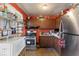 Cozy kitchen with stainless steel refrigerator and gas range at 3432 Joan Pl, Indianapolis, IN 46226