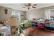 The cozy living room features a ceiling fan and hardwood floors at 3432 Joan Pl, Indianapolis, IN 46226