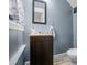 Compact half-bathroom features a dark vanity and modern fixtures at 3515 Guilford Ave, Indianapolis, IN 46205