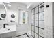Well-lit modern bathroom featuring stylish black fixtures and a glass-enclosed shower at 3515 Guilford Ave, Indianapolis, IN 46205