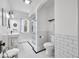 This bathroom has white tiled walls and hexagon patterned floors at 3515 Guilford Ave, Indianapolis, IN 46205