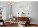 Charming dining area featuring a decorative sideboard, wood floors, and natural light at 3515 Guilford Ave, Indianapolis, IN 46205